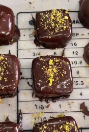 Dark chocolate ganache cubes finished with gold leaf flecks