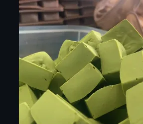 Matcha ganache cubes, freshly cut and dusted, in a tray at the Ricci commissary